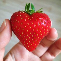 bright red, heart shaped strawberry